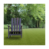 Wooden chair on a grassy lawn with trees in the background
