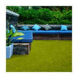 Outdoor seating area with blue cushions on a wooden bench against a green artificial grass background